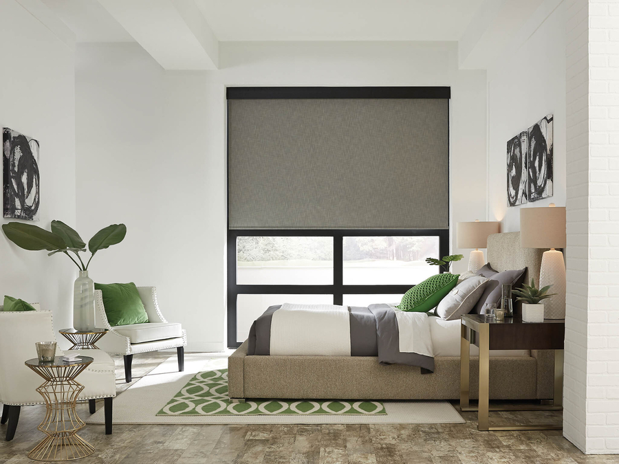 Modern bedroom with a large Lutron motorized shade on the window.