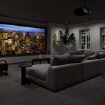 A high-end home theater with a Sony projector displaying a picture of a city landscape.